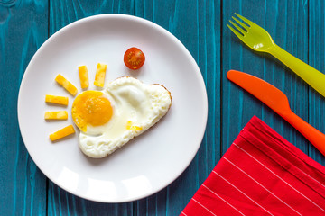 sunshine fried eggs breakfast for kid on blue background