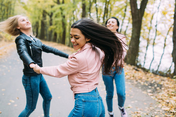 Fototapeta premium Happy three teen friends. Stylish girls in the autumn park posing.