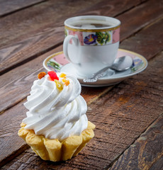 Sweet cake with coffee on wood rustic table