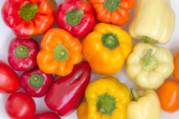 Peppers of different colors on a white background. Top view