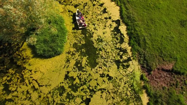Aerial shot grandpa with his grand kids in row boat