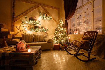 Calm image of interior modern home living room decorated christmas tree and gifts, sofa, table covered with blanket.