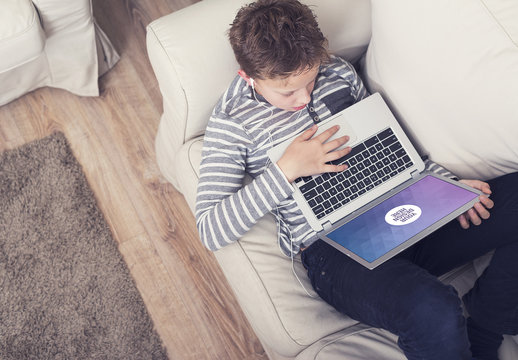Young User with Laptop on Couch Mockup 2