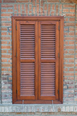 window closed with wooden exterior shutters