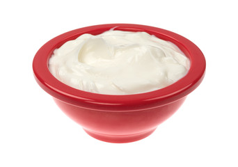 Bowl of cocoa butter cream skin lotion isolated on a white background.