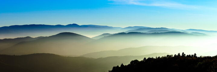 Aerial view of colorful autumnal mountains, foggy sunset