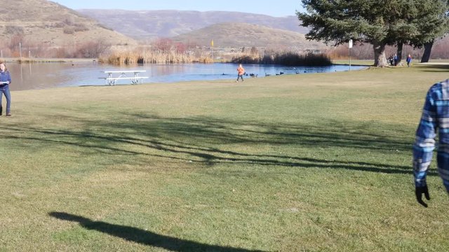 Friends play a game of frisby in the park