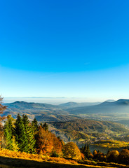 Obraz premium Aerial view of colorful autumnal mountains, foggy sunset