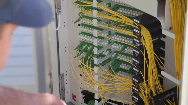 Technician works in the telecommunications outdoor box