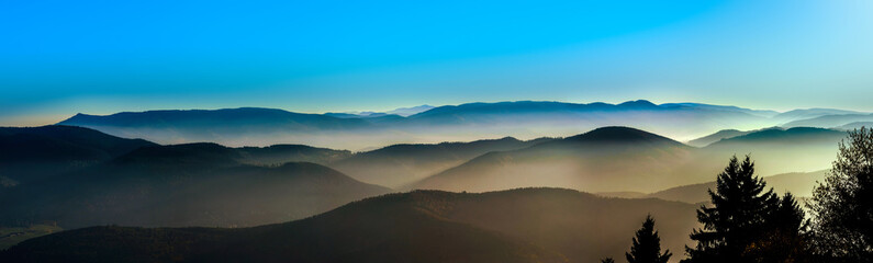 Aerial view of colorful autumnal mountains, foggy sunset - Powered by Adobe