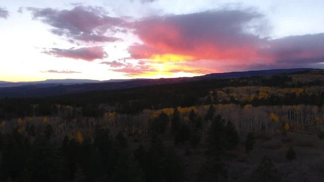 Aerial dolly shot of a beautiful mountain sunset and fall colors