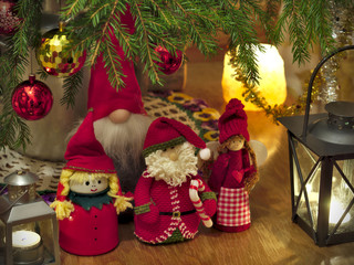 Homemade Xmas decoration elves under Christmas tree closeup. Happy holidays!