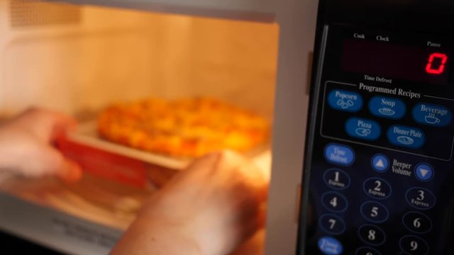 Man Puts In Microwave Pizza In A Hotel Room