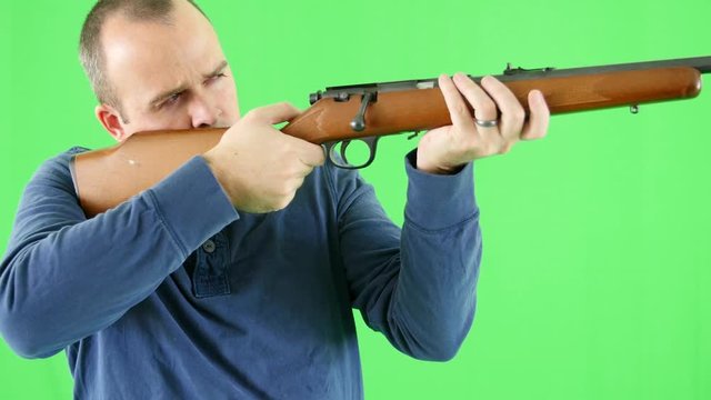 A green screen shot of a shooter with a rifle at camera