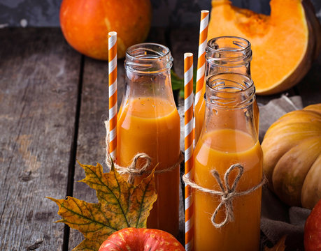 Bottles of healthy pumpkin juice. Selective focus 