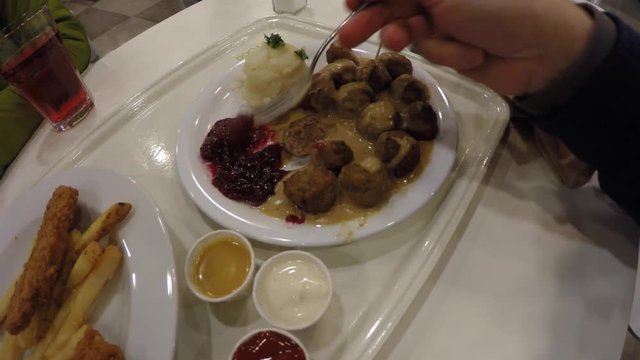 Man eating Swedish meatballs