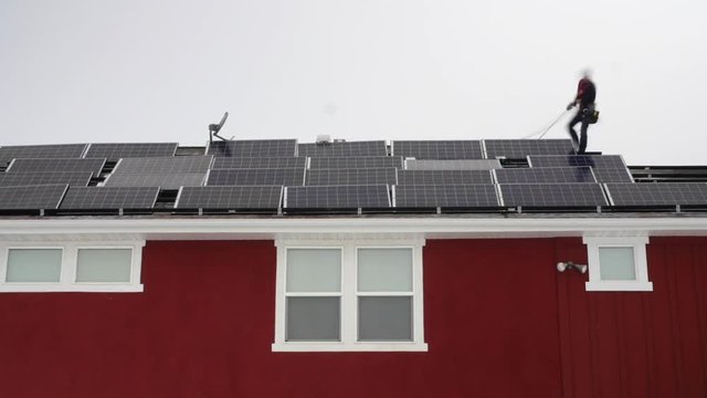 A timelapse of crews placing solar panels on the roof of a house