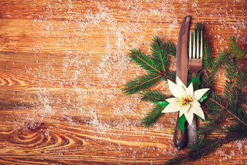 Christmas table place setting with christmas pine branches and p