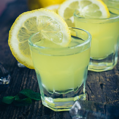 Italian traditional liqueur limoncello with lemon