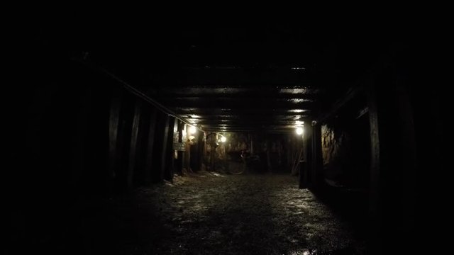 Camera moving shot through a dark coal mine at glace bay