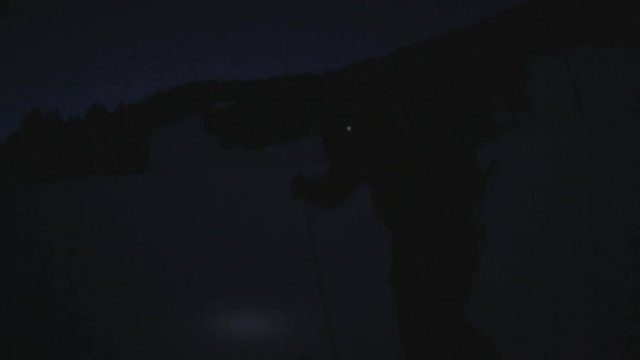 Skier hikes up mountain in the dark