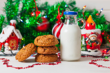 Cookies and milk on christmas background.