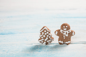 Gingerman and Christmas tree made of gingerbread dough as backgorund