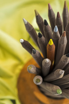 Pile of Color Pencils 
Gray color pencils and one of them with yellow color
