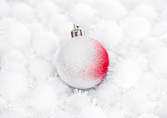 Red christmas ball on snow balls on white