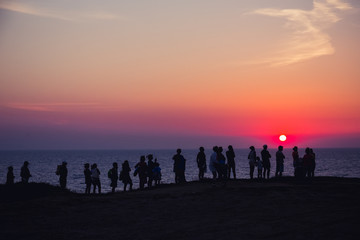 Sunset in Crimea/ A group of people on the background of beautiful sunset in Crimea