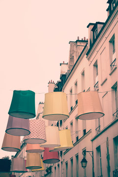 Linen lamps hanging above a Paris street