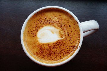 Cup of vegan non-dairy cappuccino coffee with almond milk