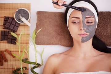 Spa Mud Mask. Woman in Spa Salon. Face Mask. Facial Clay Mask. Treatment