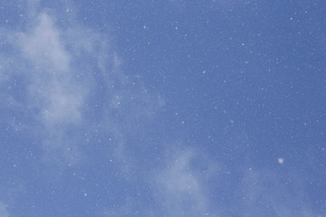 Snowfall in blue sky