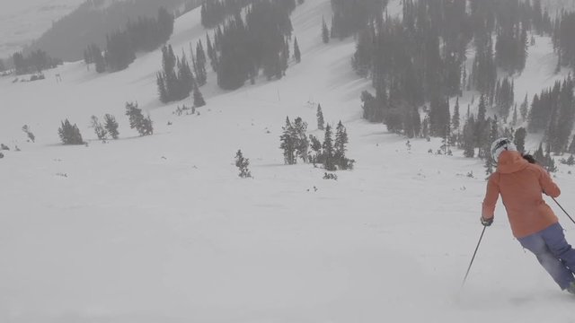 woman ski down wide open slope in perfect winter conditions