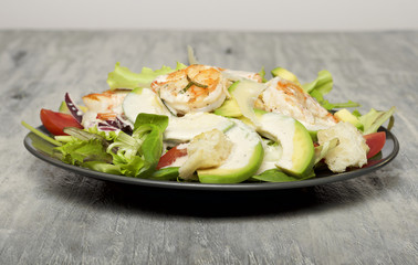 Caesar salad with prawns and avocado