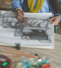 Young woman drawing a picture. Selective focus and small depth of field.