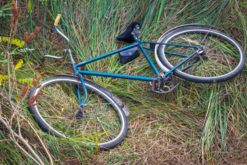 Fototapeta na wymiar Old Soviet bike lying on the grass