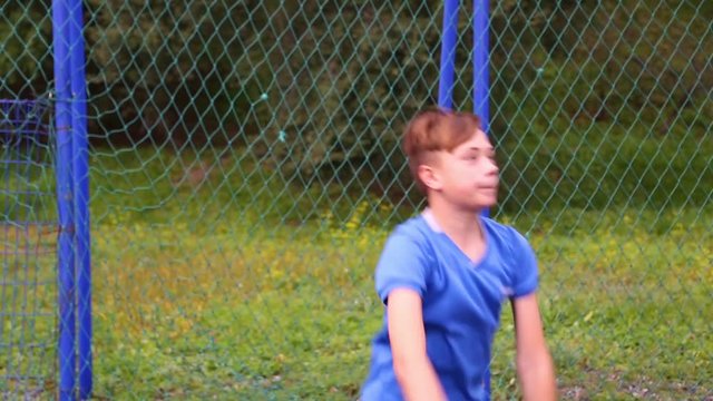 Boy footballer player throws the ball from sideline