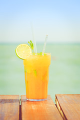 Mango mojito on the wooden pier. Concept of luxury tropical vaca