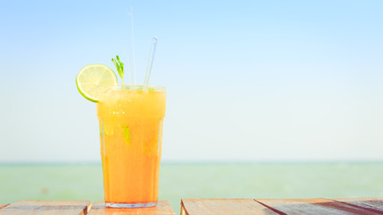 Mango mojito on the wooden pier. Concept of luxury tropical vaca