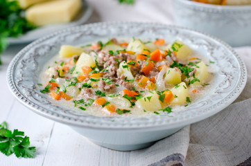 Cheese soup with vegetables and minced meat