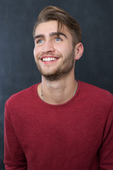 Obraz premium Portrait of a fashionable young man on dark background, chalkboa