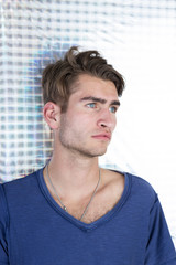 Fototapeta premium Portrait of an handsome young man with interesting background a