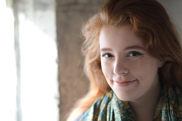 Fototapeta premium Red Haired Woman in Blue and Gold Scarf