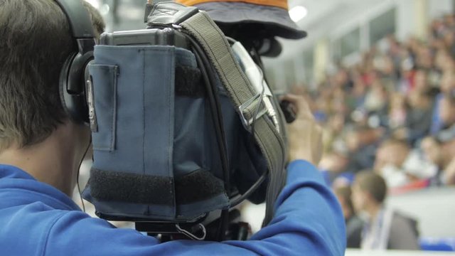 Cameraman shooting hockey game.
