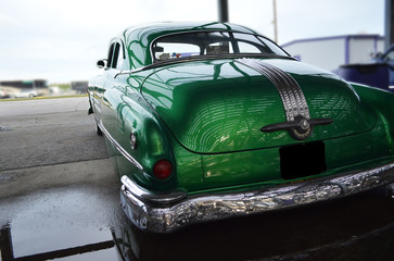 Green Car Rear/Rear view of classic green car in the shade