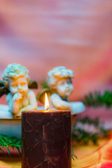 Advent candle with three angels and fir sprigs