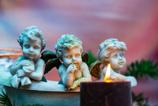 Advent candle with three angels and fir sprigs