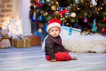 Cute christmas little baby child boy among Christmas decorations